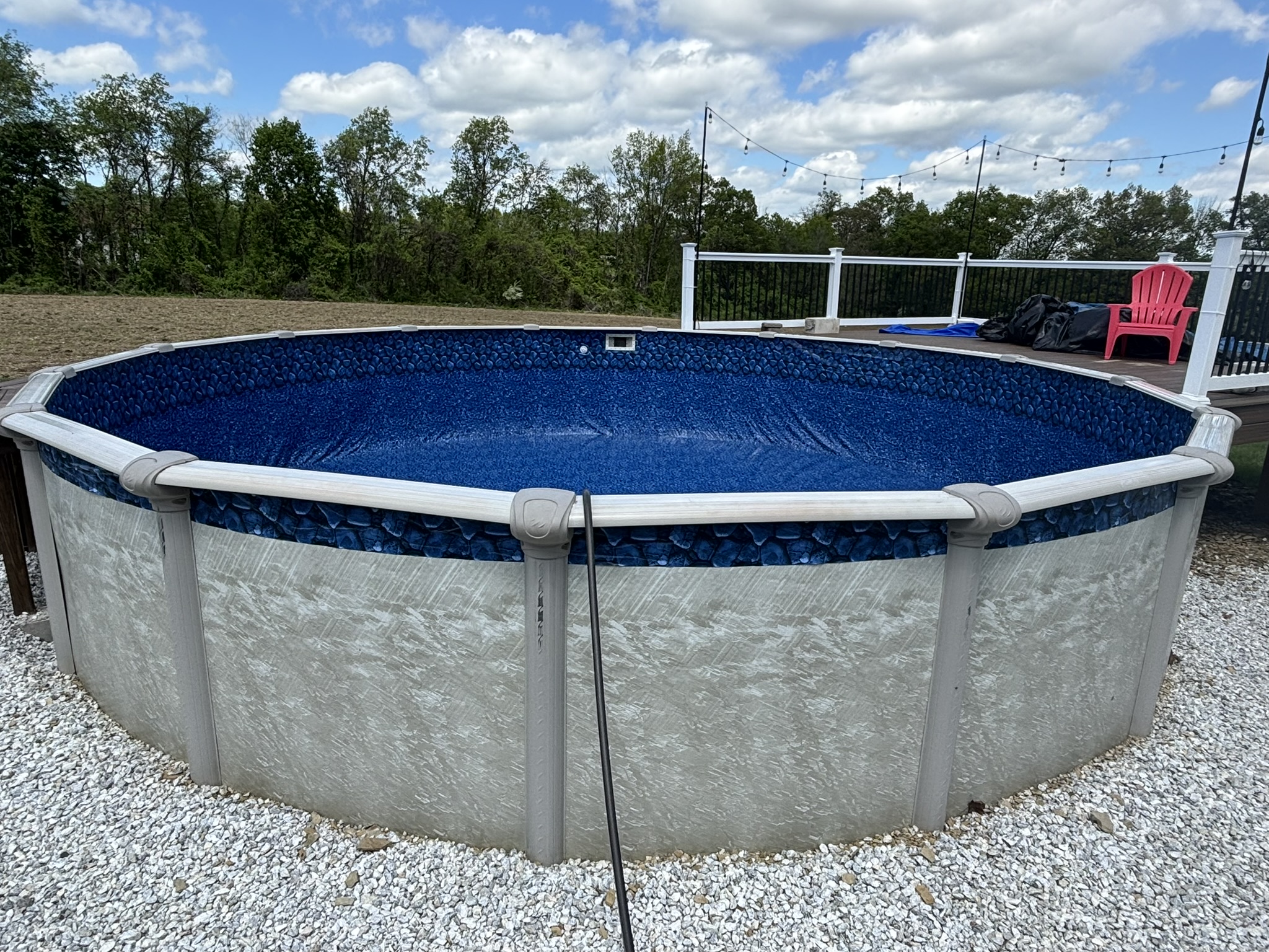 Finished above-ground pool with deck and backyard upgrades